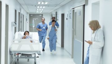 nurses running down hospital corridor